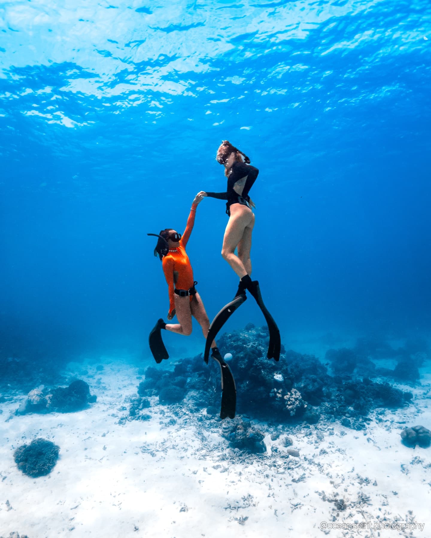 Two freedivers ascending together during a Freedive Sulawesi training session in Bira